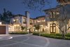 An expansive motor court of hand-laid granite leads to phenomenal living spaces. Photo of Benedict Canyon Villa modern home