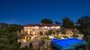 Situated atop a secluded canyon, the home boasts incredible outdoor space with multiple terraces and patios for grand-scale entertaining. Photo 2 of Benedict Canyon Villa modern home