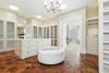 Dual showroom closets feature custom cabinetry, large center islands and security cameras, while Solatube light tunnels provide inimitable natural light. Photo 8 of Benedict Canyon Villa modern home