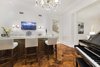A refined salon holds a stunning marble slab bar and French doors to the loggia. Photo 9 of Benedict Canyon Villa modern home