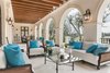 French doors off the great rooms lead to an expansive dining and lounging loggia. Photo 10 of Benedict Canyon Villa modern home