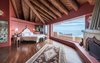 A voluminous master suite showcases wood beams, a fireplace, and sweeping ocean views. Photo 8 of Malibu Colony Road modern home