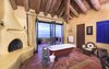 The master bathroom flows seamlessly to an oversize oceanfront terrace. Photo 9 of Malibu Colony Road modern home