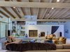 Smooth surfaces were favored over the home's original stone and wood, while built-in bookshelves add warmth to the space. Photo 5 of Midcentury Post and Beam In Fryman Canyon modern home