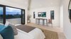 Modern home with Bedroom, Bed, Recessed Lighting, Chair, and Light Hardwood Floor. A voluminous master suite features vaulted ceilings, dual showroom closets and sliding pocket doors to a large terrace. Photo 10 of A 1930s Spanish Colonial in Los Feliz Reimagined for the 21st Century