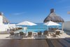 Modern home with Outdoor, Swimming Pools, Tubs, Shower, Salt Water Pools, Tubs, Shower, and Large Patio, Porch, Deck. The saltwater, infinity-edge pool with "floating" dining patio and palapa roof. Photo 2 of A Contemporary Makeover Transforms Oceanfront Villa Serena