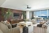 Modern home with Living Room. The great room with dark-hued accent wall and receding glass doors. Photo 3 of A Contemporary Makeover Transforms Oceanfront Villa Serena