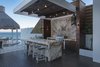 Modern home with Outdoor. Marble and wood poolside cooking area with casual, countertop seating. Photo 5 of A Contemporary Makeover Transforms Oceanfront Villa Serena