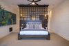 Modern home with Bedroom and Bed. Master bedroom suite with gallery walls and rich wood accents. Photo 6 of A Contemporary Makeover Transforms Oceanfront Villa Serena