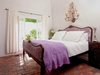 Modern home with Bedroom, Accent Lighting, Night Stands, Bed, and Brick Floor. The master suite boasts original red brick floors and French doors to a quaint garden patio. Photo 8 of A Charming 1920s Spanish in West Hollywood's Storied Norma Triangle