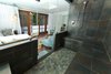 Modern home with Bedroom. The home's spa-like guest house holds its third bedroom and full bathroom, kitchenette, and luxurious steam room. French doors create an effortless connection to the pool beyond. Photo 12 of A Charming 1920s Spanish in West Hollywood's Storied Norma Triangle