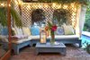 A relaxed seating area off the main house is surrounded by greenery and serves as a peaceful retreat. Photo 13 of A Charming 1920s Spanish in West Hollywood's Storied Norma Triangle modern home