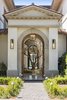 Upon entry, a light-filled atrium, crowned by a 100-year-old olive tree, leads to an open-air lobby with a retractable glass ceiling that transforms the space at the push of a button. Photo of Architecturally Inspired Living in Beverly Hills modern home