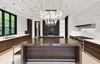 A stunning chef’s kitchen, complete with a temperature-controlled wine room, features dual marble islands, elegant light fixtures, and vanishing pocket doors which open the space to an al fresco dining area.
Photo 6 of Architecturally Inspired Living in Beverly Hills modern home