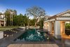 Lush, parklike grounds are studded with mature trees and heightened by a resort-caliber pool, spa, and cabana with water features. Photo 13 of Architecturally Inspired Living in Beverly Hills modern home