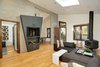 Towering ceilings and skylights lend the space incredible light and scale, while contrasting, organic finishes add dimension to the interiors. Photo 3 of Sleek West Hollywood Contemporary modern home