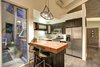 The full kitchen with breakfast bar and stainless steel appliances. Photo 11 of Sleek West Hollywood Contemporary modern home