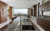 Custom fabricated by Leicht, a sophisticated chef's kitchen features Caesarstone countertops and Miele appliances. Photo 4 of A Showpiece on Shadow Hill modern home