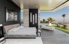 A voluminous master suite features an elegant sitting area with fireplace and sliding walls of glass that connect to a spacious terrace with skyline views. Photo 6 of A Showpiece on Shadow Hill modern home