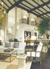 Soaring ceilings and exposed beams lend a sense of scale and timeless grandeur to the living spaces. Photo 3 of A Wallace Neff Inspired Masterpiece in Desert Highlands modern home