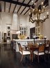 An expansive, two-story kitchen features soapstone countertops, a large butcher block island, and a professional stainless steel appliance package, including a glass door Traulsen refrigerator and freezer, Thermador indoor grill, and custom La Cornue French stove. Photo 5 of A Wallace Neff Inspired Masterpiece in Desert Highlands modern home