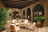 Rounded French doors inspire a seamless connection to an expansive dining and lounging loggia. Photo 9 of A Wallace Neff Inspired Masterpiece in Desert Highlands modern home