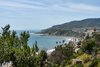 Dynamic, far-reaching views encompass nearby hillsides and the beaches below. Photo 6 of Castillo del Mar Brings Italian Style to Pacific Palisades modern home