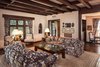 Modern home with Living Room, Chair, Sofa, Table Lighting, and Medium Hardwood Floor. Spacious living areas are heightened by wide plank hardwood floors, exposed beams, and casement windows with diamond-patterned grilles. Photo 3 of Authentic 1930s Country English Compound in Fryman Canyon