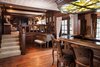 Modern home with Living Room, Chair, Ceiling Lighting, and Medium Hardwood Floor. An elegant bar with steps up to a sitting area with built-in bookshelves. French doors lead out to the backyard. Photo 4 of Authentic 1930s Country English Compound in Fryman Canyon