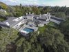 Modern home with Exterior. The stunning estate is one of the few properties situated on the exclusive Bel Air Country Club golf course. Photo of Old Hollywood Glamour With Modern Appeal in Bel Air