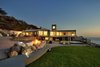 Modern home with Outdoor, Trees, Grass, Front Yard, Walkways, Concrete Patio, Porch, Deck, Decomposed Granite Patio, Porch, Deck, Gardens, and Concrete Fences, Wall. Situated on a coastal bluff 100 feet above the Pacific Ocean, the sophisticated seaside retreat offers a taste of Malibu, Big Sur and Pacific Coast Highway moments from San Francisco and Silicon Valley. Photo of An Oceanfront Sanctuary on the California Coast