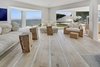 Modern home with Living Room, Chair, Sofa, Recessed Lighting, and Light Hardwood Floor. Rustic-modern interiors are designed to blend seamlessly with the natural environment, with living spaces oriented toward spectacular ocean views. Photo 4 of An Oceanfront Sanctuary on the California Coast