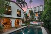Modern home with Outdoor, Back Yard, Grass, Swimming Pools, Tubs, Shower, and Concrete Fences, Wall. Located just north of the Sunset Strip, this 1928 Spanish home has been exquisitely reimagined for contemporary living. Photo of A Reimagined Spanish Hideaway in the Hollywood Hills