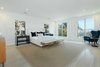 Modern home with Bedroom, Bed, Light Hardwood Floor, and Dresser. The expansive master suite showcases sweeping city views. Photo 6 of A Reimagined Spanish Hideaway in the Hollywood Hills