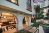 Modern home with Outdoor. A series of archways leads to an open, poolside cabana ideal for lounging and entertaining. Photo 7 of A Reimagined Spanish Hideaway in the Hollywood Hills
