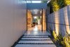 Modern home with Exterior and House Building Type. A tranquil meditation garden leads to a light-filled entrance gallery punctuated by a glass-paneled ceiling. Photo 2 of An Architectural Gem on the Bird Streets of Los Angeles