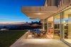 Modern home with Outdoor, Trees, Back Yard, Grass, and Large Patio, Porch, Deck. Gracious outdoor spaces are seamlessly integrated with the interiors through sliding walls of glass. Photo 8 of An Architectural Gem on the Bird Streets of Los Angeles