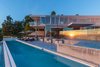 Modern home with Outdoor, Trees, Large Pools, Tubs, Shower, Back Yard, Concrete Patio, Porch, Deck, Infinity Pools, Tubs, Shower, and Vertical Fences, Wall. A 70’ infinity-edge pool and spa bear the illusion of spilling dramatically over the hillside. Photo 9 of An Architectural Gem on the Bird Streets of Los Angeles