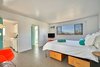 Modern home with Bedroom. Spacious guest rooms boast picturesque desert views and well-equipped kitchens. Photo 5 of An Award-Winning Midcentury Modern Hotel & Spa Hits the Market