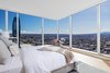 Modern home with Bedroom. A corner master bedroom suite captures panoramic city views through towering window walls with built-in power window shades. Photo 3 of Two-Story Penthouses Atop Metropolis Bring All of Los Angeles Into View