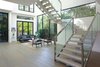 Expansive windows and soaring ceilings enhance the home's light and scale. Photo 3 of A Newly Built Architectural Estate Dazzles in L.A.’s Beverly Grove modern home