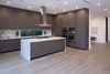 The open, European chef's kitchen with a large center island. Photo 4 of A Newly Built Architectural Estate Dazzles in L.A.’s Beverly Grove modern home