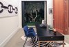 A refined office off the main level with folding Fleetwood doors to the front courtyard. Photo 5 of A Newly Built Architectural Estate Dazzles in L.A.’s Beverly Grove modern home