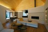 Modern home with Living Room, Gas Burning Fireplace, Chair, Accent Lighting, Coffee Tables, Sofa, and Medium Hardwood Floor. Family Room & Dining Space Photo 5 of Lighthus