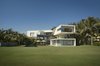 Modern home with Outdoor, Garden, Grass, and Concrete Patio, Porch, Deck. View from the Gulf Course to the House Photo 11 of La Caracola Beach House
