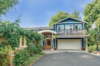 Modern home with Exterior, House Building Type, Wood Siding Material, and Curved RoofLine. After shot of the front Photo 3 of Massive Addition does not over-whelm