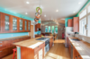 Modern home with Kitchen, Medium Hardwood Floor, Refrigerator, Range, Wood Counter, Drop In Sink, Cooktops, Microwave, Wood Cabinet, and Ceiling Lighting. New kitchen uses color in a big way Photo 6 of Massive Addition does not over-whelm