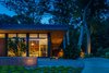 Modern home with Exterior, Metal Siding Material, Wood Siding Material, House, Flat RoofLine, and Glass Siding Material. The cantilevered roof dramatically reaches out to shelter the house as well as outdoor areas and entryways. Photo of Pleasant Street Residence