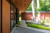 Modern home with Exterior, Mid-Century Building Type, Wood Siding Material, House, Glass Siding Material, Metal Siding Material, and Flat RoofLine. The 6’ cantilevered overhang provides ample shelter for weather and shading from the midday summer sun. Careful detailing ensured perfect alignment between the soffit and interior ceiling, as well as floor to ceiling windows. Photo 8 of Pleasant Street Residence