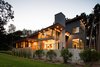 Modern home with Exterior, Wood Siding Material, Metal Siding Material, Concrete Siding Material, Shed RoofLine, Glass Siding Material, and House Building Type. The stainless steel column is set outboard of the envelope to allow for a corner opening wall system. Photo 4 of Dogwood Residence